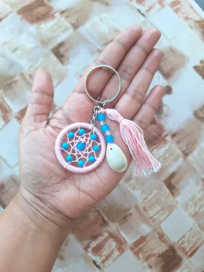 A pink and blue shell dreamcatcher keychain, showcasing a playful color combination for a fun, beachy vibe.