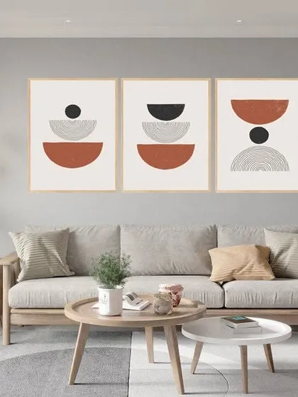 This set of three abstract art frames features a conglomerate of ringlets and semi-circles. The earthy tones and geometric patterns create a cohesive and modern triptych perfect for a large wall.