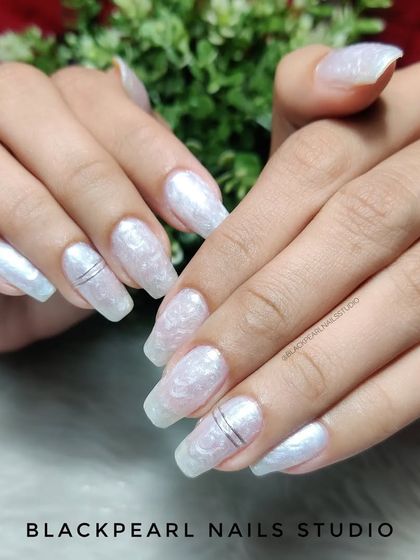 An elegant set featuring a pearl effect gel polish. This gives the nails a flawless, pearlescent shimmer that is both subtle and sophisticated, perfect for a classy look.