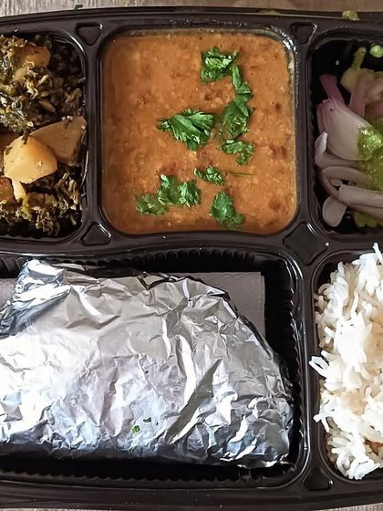 A winter special thali with dal and aloo methi (potato and fenugreek). The earthy flavor of methi is a seasonal delight.