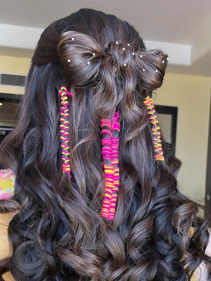 A full back view of this creative Mehendi hairstyle. It features a large bow made of hair, pearl details, and colorful thread braids, combining multiple techniques you'll learn in my class.