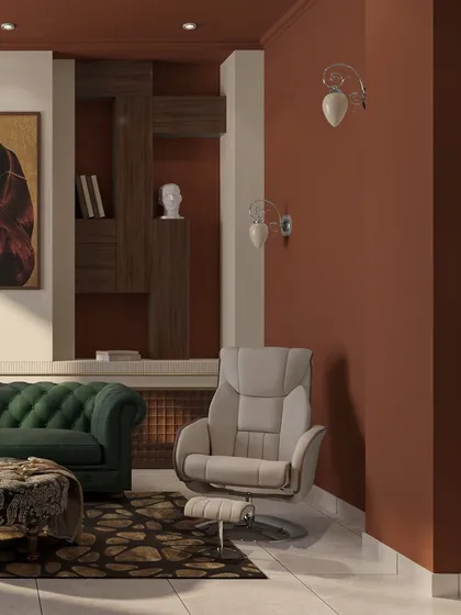 A comfortable recliner offers a perfect spot for movie nights. The wall sconces add to the room's moody and sophisticated ambiance.