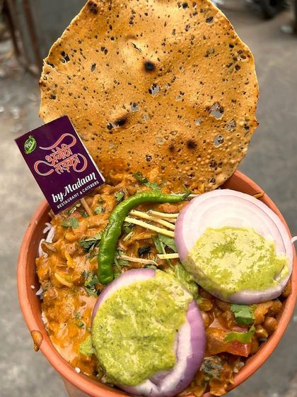 A hearty and comforting meal of Rajma Chawal served in a matka with papad and chutney. This is the taste of home, prepared with our special Angithi Tadka touch.