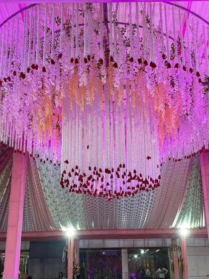 Another angle of the floral chandelier, showcasing its scale and the beautiful way it catches the light.
