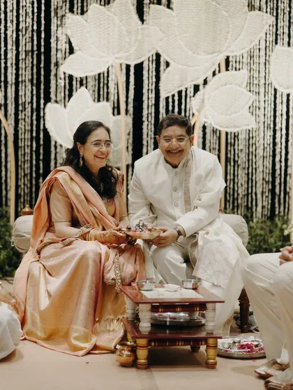 The parents of the bride seated at the mandap, framed by lotus-themed decor. The mother's Kanjeevaram saree was a central element that tied into the overall wedding branding and storytelling.