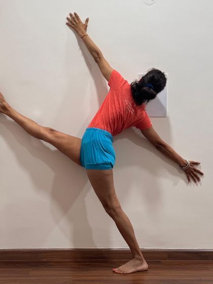 Parivritta Trikonasana (Revolved Triangle Pose) at the wall. You are your own teacher. You understand yourself the best, and you can have a better teacher inside you who is with you all the time.