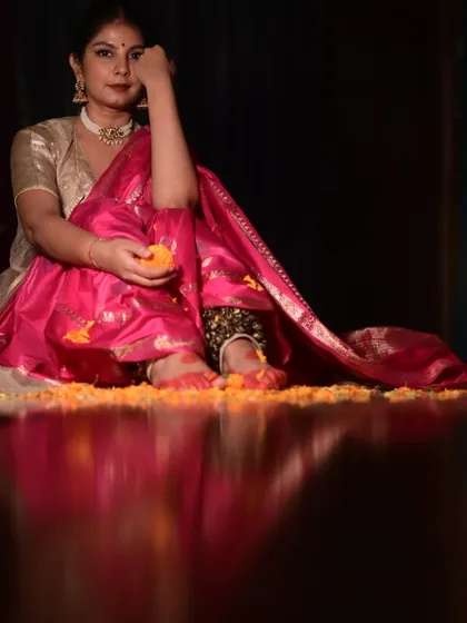 A serene moment captured amidst flowers and diyas. This image from a Holi photoshoot combines the festive colors with a sense of peace and introspection.