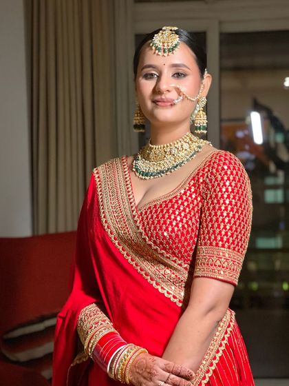 A portrait of the bride showcasing her sleek center parted bun. This style is a favorite for its clean lines and how it beautifully showcases facial features and jewelry.