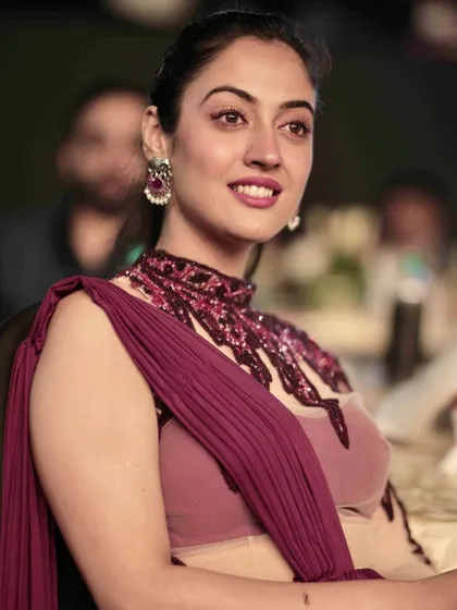 A candid shot of an actress enjoying the show. These photos add a narrative element, showing the guests' experience at the event.