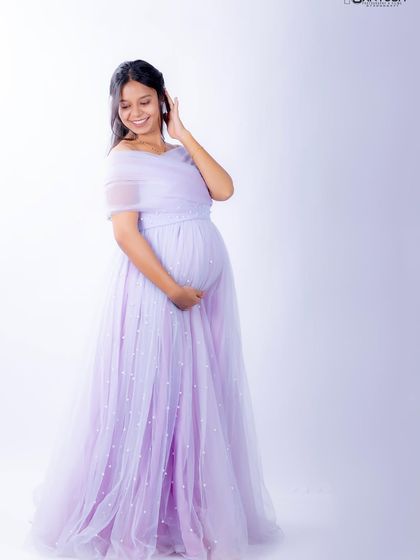 A full-length view of the Breezy gown. The A-line skirt is light and airy, and the scattered pearls add a touch of subtle sparkle.