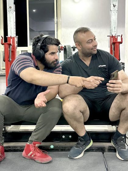 Sharing a laugh with my training partner in the gym. We train hard, but we also have fun.