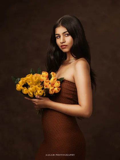 A closer crop that focuses on her direct and engaging expression, creating a more intimate and personal portrait.