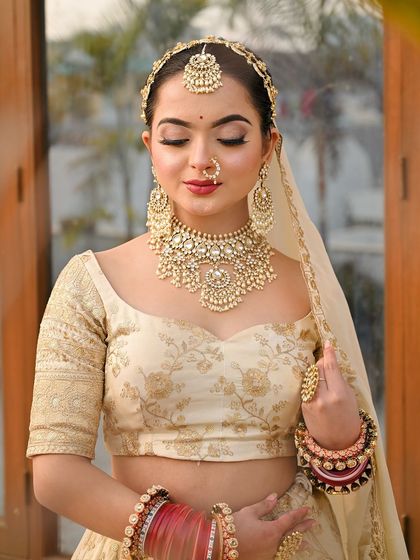 A close-up of this elegant ivory look. The off-shoulder style blouse and the heavy kundan choker create a modern yet traditional feel.