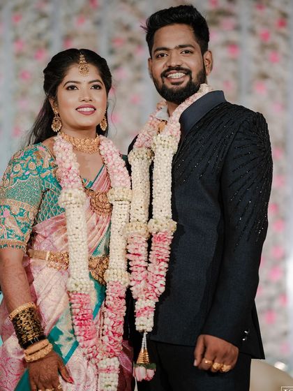 My beautiful bride and her partner sharing a happy moment. Her makeup was designed to be soft and natural, complementing her pastel pink and green saree perfectly.