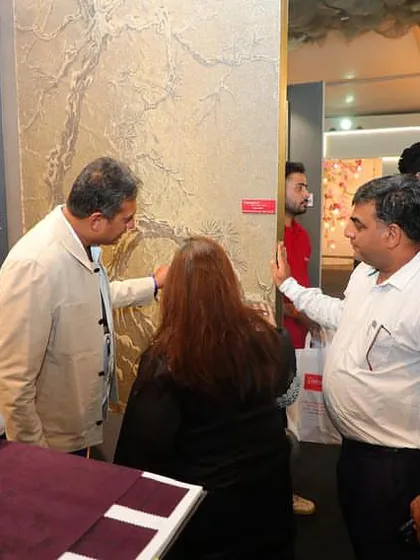Guiding visitors through the textured wallcoverings at our Ajio Luxe Weekend booth. These tactile surfaces are always a point of fascination.