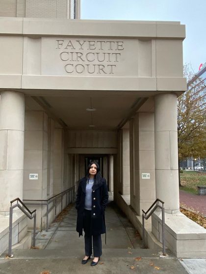 Standing at the entrance of the Fayette Circuit Court in Kentucky. It was here I first encountered the use of "white noise" in a courtroom, a sound used to ensure privacy during sidebar conversations between a judge and attorneys. It was interesting to compare their procedures with our own, especially in sensitive cases.