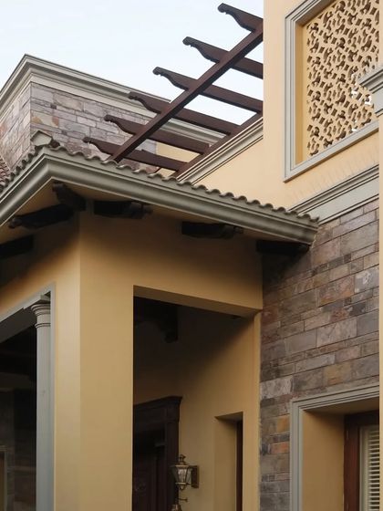 This angle highlights the balance and sophistication of the design, where meticulous detailing like the wooden pergola and stone accents harmonize with the expansive landscape.