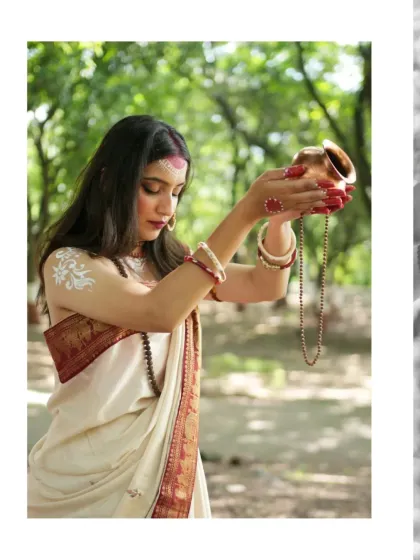 An offering of peace and devotion. The model, portraying Parvati, makes a water offering from a traditional copper pot, set against a serene forest backdrop.