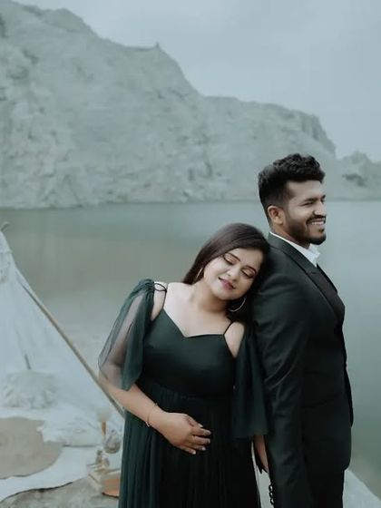 A stylish and serene pre-wedding portrait by a quarry lake. The couple's pose and the calm water create a sense of peaceful romance.