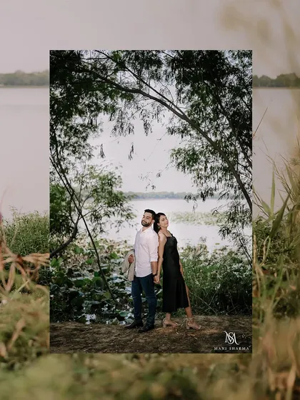 A back-to-back pose under a natural arch of trees by the lake. This classic pre-wedding pose is framed beautifully by the surrounding nature.