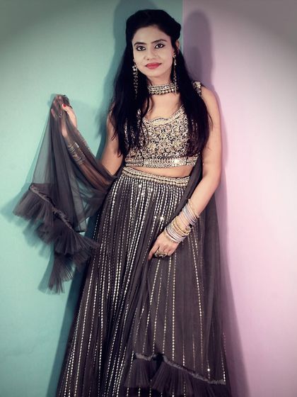 Another look at our modern black striped lehenga, showing off its ruffled dupatta. It's a lightweight and comfortable choice for dancing the night away.