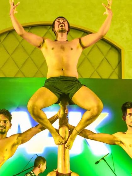 A powerful pose from our team during a stage show. The strength and intensity of the athletes are on full display, capturing the warrior spirit of Mallakhamb.