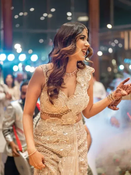 The bride-to-be dances with joy, a candid shot capturing the energy and happiness of the engagement party.