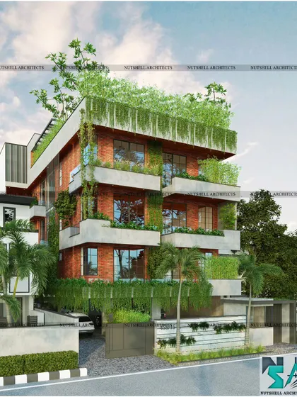 Designed for a lush plot in Noida, this residence embraces nature. The facade uses exposed red brick cladding and integrates several full-grown trees and layered planters, seamlessly blending the structure with its green surroundings.