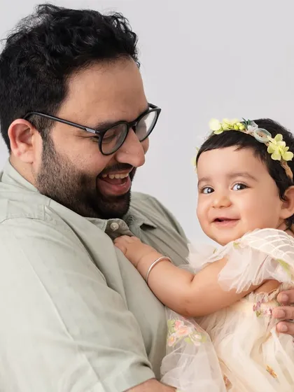The joy is contagious in this photo of a father and his smiling baby. I encourage playful interaction to bring out these genuine, happy expressions.