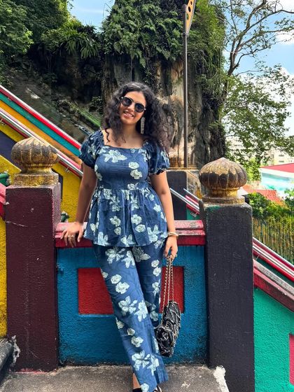 A photo from my May photo dump. This shot at Batu Caves in Malaysia shows off a cute blue floral co-ord set against a colorful, cultural backdrop.
