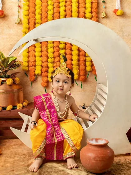 A little Krishna sitting gracefully on a crescent moon prop. Our unique props help create stunning and memorable images for your child's festive photoshoot.