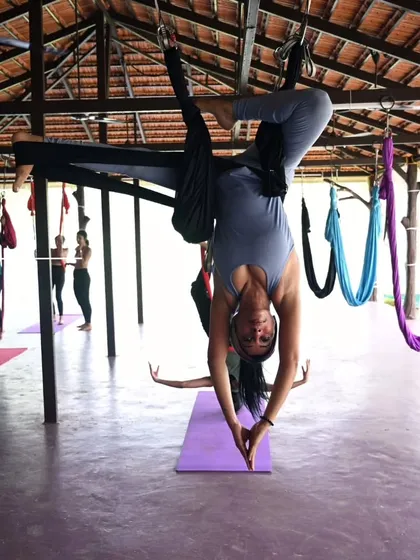 A graceful inversion with hands in prayer. This pose combines the physical challenge of being upside down with a moment of quiet introspection.