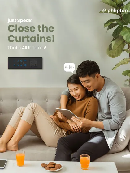 A couple relaxes on the couch while a simple voice command, "Close the Curtains," takes care of their privacy. Your voice is your new remote control.