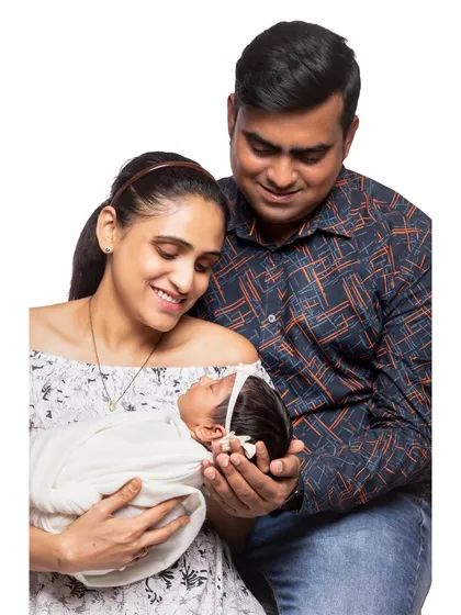 A candid studio moment where new parents are completely absorbed in their beautiful baby. I focus on capturing these genuine interactions that reflect the real, unfiltered love within your family.