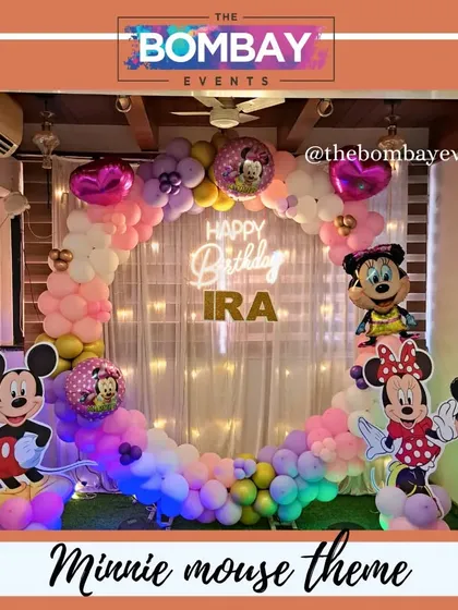 A slightly different take on the Minnie and Mickey theme, this one uses a rainbow pastel balloon arch against a fairy-light curtain, creating a soft and magical glow for Ira's birthday.