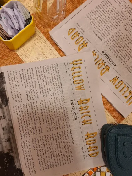 The newspaper-style menu at Yellow Brick Road, a nostalgic touch that tells the story of the iconic restaurant.