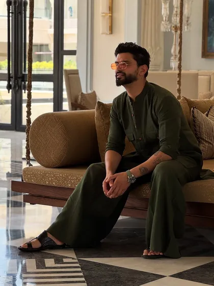 A relaxed, seated pose in the YJHD-inspired outfit, perfect for a destination wedding vibe.