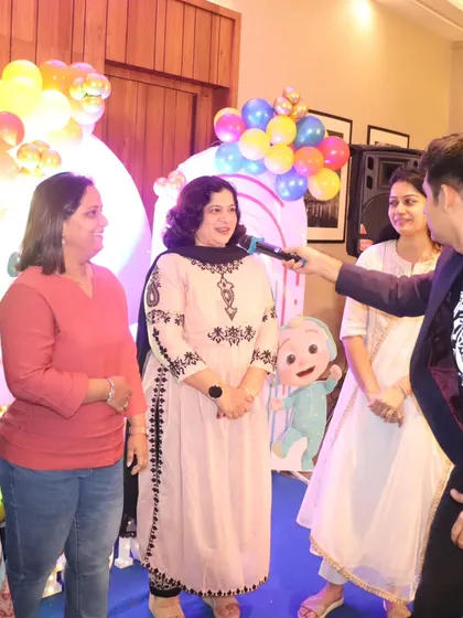 Interacting with guests during a birthday party. I love to move around the room and make sure everyone feels included in the festivities.