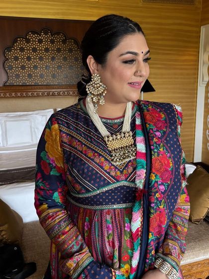A close-up of the client with her festive braided hairstyle. The front features small, neat braids pulled back into a ponytail, keeping the hair off the face while still looking stylish.