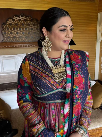 Another shot of the client, showing her beautiful traditional jewelry which pairs perfectly with the braided hairstyle.