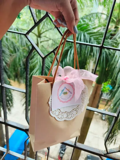 Even the smallest gifts get special treatment. This is the packaging for my crochet heart pot, complete with a custom tag and delicate doily, all tucked into a neat little bag.
