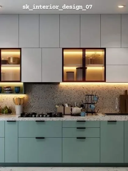 A dual-tone kitchen with mint green lower cabinets and white upper cabinets. The terrazzo-style backsplash and backlit glass shelves add a trendy, modern touch.