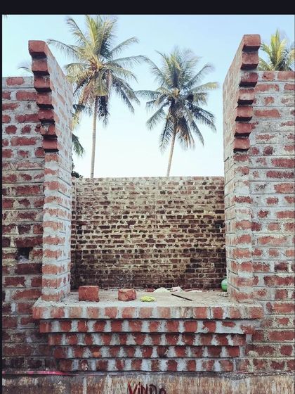 A view through an unfinished window opening at the Srirangapatna site. The corbelled brick base for the window seat is visible, showcasing how we integrate functional details into the structure right from the beginning.