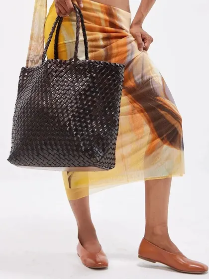 The Axel Large Tote in a deep, classic black weave. This spacious and durable bag showcases the artistry of handwoven elegance, perfect for everyday use.