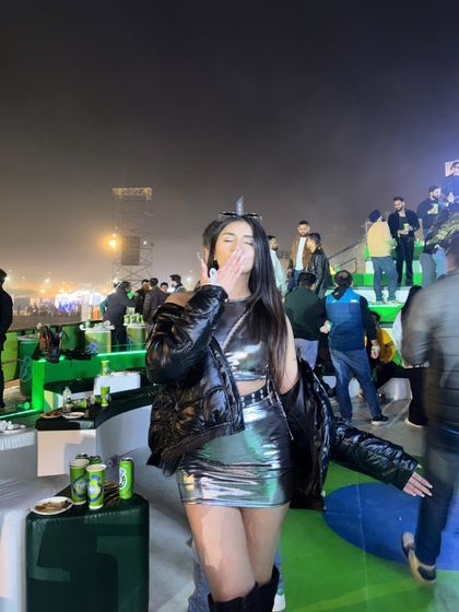 Blowing a kiss to the camera, feeling the concert vibes.