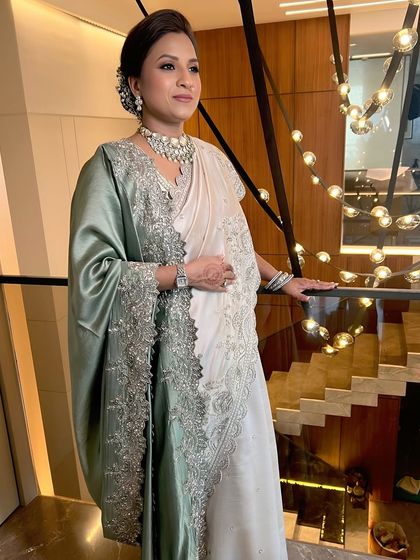 A full shot of the mother, her beautiful saree and elegant makeup making her look regal.