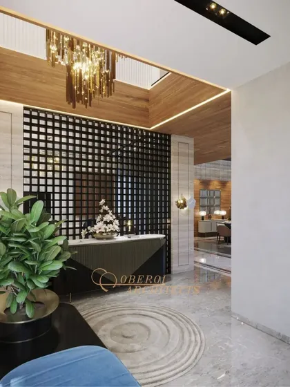 A detail of the entryway console table, set against a dramatic black grid partition and illuminated by a skylight and chandelier.