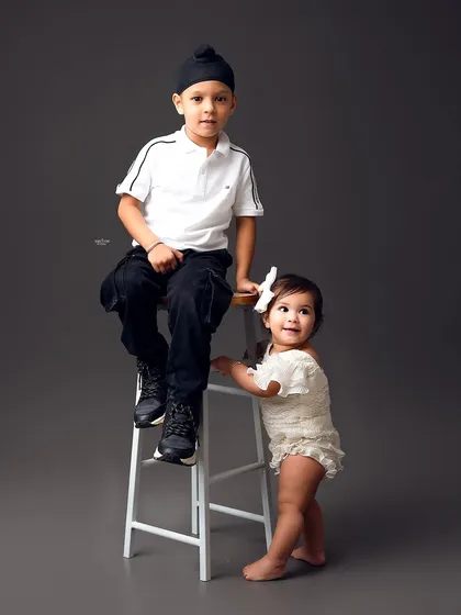 Big brother looking out for his little sister in this adorable sibling portrait.
