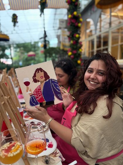 Another happy painter at Nicole's birthday celebration, showing off her colorful creation. These parties are all about having fun and making memories.