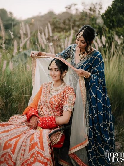 A sister adjusting the bride's veil just before the ceremony. This simple act of love and support makes for a beautiful, storytelling image.